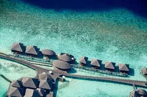 Stunning aerial shot of luxurious overwater villas in the Maldives, showcasing crystal clear turquoise waters. jigsaw puzzle