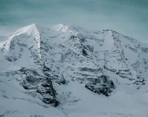 Stunning view of snow-covered mountains in Graubünden, Switzerland, captured in winter. jigsaw puzzle