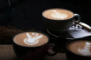 Close-up of beautifully crafted latte art in three cups of coffee, showcasing intricate designs. jigsaw puzzle