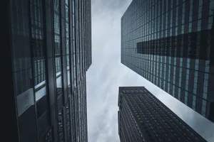 Upward view of New York City's skyscrapers against a cloudy sky, showcasing modern architecture. jigsaw puzzle