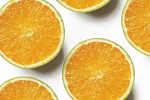 Vibrant slices of fresh oranges on a clean white backdrop, showcasing juicy citrus appeal. jigsaw puzzle