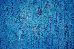 Close-up of a distressed blue cracked concrete surface, revealing rich texture and patterns. jigsaw puzzle