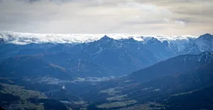 Snow-capped mountains under a cloudy sky jigsaw puzzle