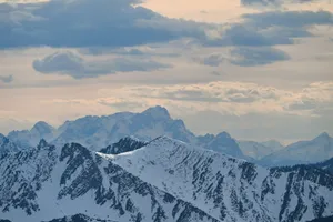 Snow-covered mountains under a cloudy sky jigsaw puzzle