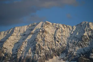 Snow-covered mountain peaks under a blue sky. jigsaw puzzle