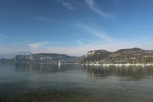 body of water near mountain under blue sky during daytime jigsaw puzzle