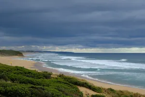 A view of a beach with waves coming in from the ocean jigsaw puzzle