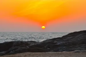 the sun is setting over the ocean on the beach jigsaw puzzle