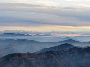 Tranquil twilight view of the Himalayas with mist and clouds, perfect for nature enthusiasts. jigsaw puzzle