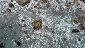 Dramatic aerial view of ocean waves crashing over rocks along Iquique's coast. jigsaw puzzle