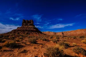 Breathtaking view of a desert with rock formations under a bright blue sky. jigsaw puzzle