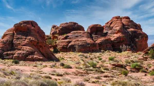 Stunning view of red sandstone rock formations in a desert landscape under a clear sky. jigsaw puzzle
