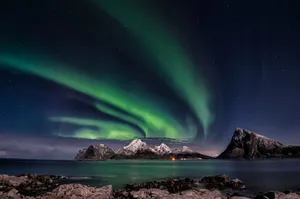 A breathtaking view of the Northern Lights over Sandnes, Norway's rugged mountains. jigsaw puzzle