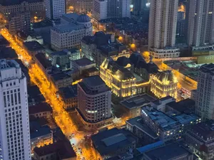 Stunning aerial night view of a vibrant cityscape with illuminated streets and buildings. jigsaw puzzle
