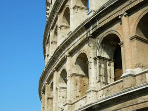 Close-up of the ancient Colosseum facade in Rome, Italy under a clear blue sky. jigsaw puzzle