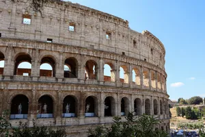 Close-up of the Colosseum's arched facade in Rome with clear blue sky. jigsaw puzzle