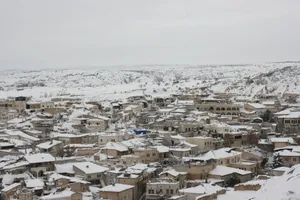 Aerial view of a snowy cityscape in Cappadocia, highlighting unique architecture. jigsaw puzzle