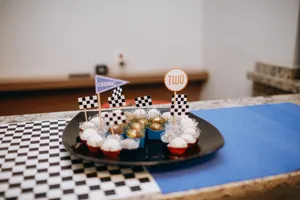 Race-themed dessert table with cupcakes and checkered flags for a birthday celebration. jigsaw puzzle