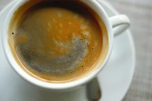 A detailed close-up shot of a steaming cup of coffee showcasing rich, swirling crema. jigsaw puzzle