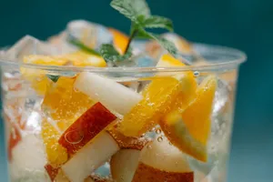 Close-up of a refreshing citrus and apple infused drink with ice in a cup. jigsaw puzzle