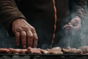 Man grilling meat outdoors with smoke rising, Belgrade, Serbia. jigsaw puzzle