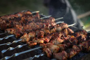 Close-up of delicious grilled meat skewers on a barbecue grill outdoors. jigsaw puzzle