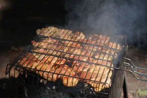 Juicy marinated chicken being grilled on a BBQ with rising smoke. jigsaw puzzle