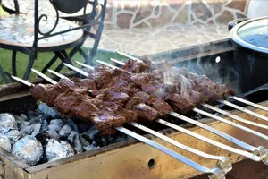 Savory skewers grilling on a charcoal barbecue, perfect for outdoor culinary delights. jigsaw puzzle