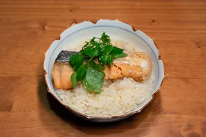 A delicious bowl of salmon and rice topped with fresh cilantro, perfect for a healthy meal. jigsaw puzzle