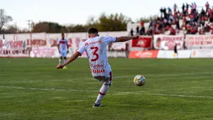 A football player kicks the ball on the field during an outdoor match with spectators. jigsaw puzzle