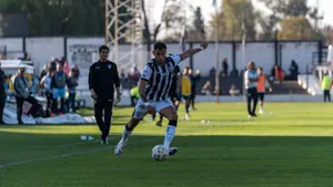 A football player in action on the field during an outdoor match, showcasing athletic skills. jigsaw puzzle