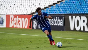 Soccer player dribbling the ball during a match on a sunny day. jigsaw puzzle