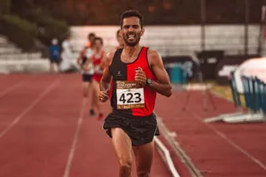 Focused male athlete competing in track race, showing determination and endurance. jigsaw puzzle