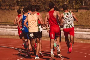 Men competing in a running event on a sunny outdoor track, showcasing athleticism and determination. jigsaw puzzle