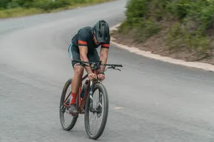 Cyclist racing on a mountain bike on a winding road during the day. jigsaw puzzle