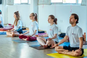 A diverse group of adults meditating indoors during a yoga session. jigsaw puzzle