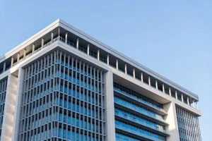 Contemporary highrise building with glass facade under a clear blue sky. jigsaw puzzle