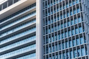 Close-up view of a modern highrise building with glass facade and geometric design elements. jigsaw puzzle