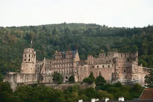 Heidelberg Castle nestled in lush greenery, showcasing its historic architecture against a forested backdrop. jigsaw puzzle