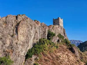 A striking view of a historic castle atop a rocky hill in Zahara de la Sierra, Andalusia. jigsaw puzzle