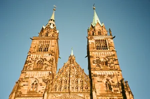 Majestic Gothic cathedral towers rise against a bright blue sky, showcasing intricate architecture. jigsaw puzzle