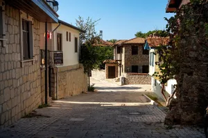 Beautiful cobblestone street flanked by stone houses in a serene historic town setting. jigsaw puzzle