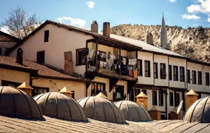 Traditional buildings in Ankara's old district with laundry hanging on balconies, under a sunny sky. jigsaw puzzle