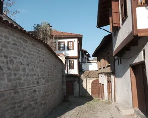 Charming old street lined with traditional stone and wooden houses under a clear blue sky. jigsaw puzzle