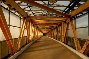 Empty pedestrian bridge with steel lattice structure and glass walls. jigsaw puzzle