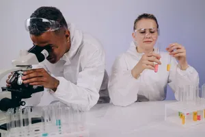 Two scientists in protective gear collaborating on a research project with microscope and test tubes. jigsaw puzzle