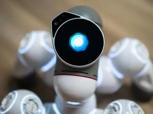 Detailed close-up shot of a futuristic toy robot with a glowing head, focused on innovation. jigsaw puzzle