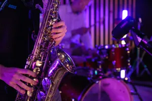 Musicians playing saxophone and drums during a vibrant live performance. jigsaw puzzle