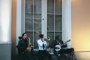 Three musicians play saxophone, trumpet, and banjo on the street, creating a vibrant jazz atmosphere. jigsaw puzzle