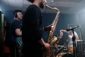 Musicians playing instruments in a recording studio, focusing on saxophonist. jigsaw puzzle